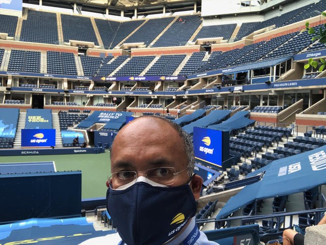 Dr. Seneviratne preparing to cover a tennis match at Arthur Ashe Stadium