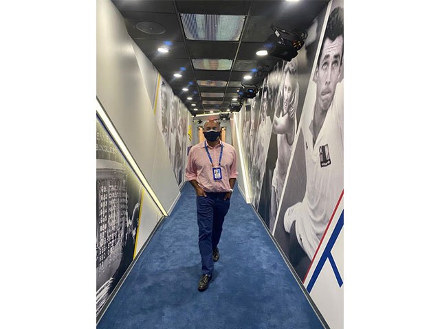 Dr. Seneviratne walking down the hall of champions at Flushing Meadows US Tennis Center